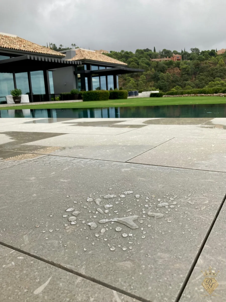 Pierre naturelle protégée par un traitement hydrofuge au bord d’une piscine